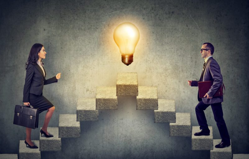 Business People Climbing A Flight Of Stairs, Stepping Up A Stairway Career Ladder With Idea Light Bulb On A Top