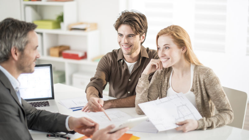 real-estate agent receives a young couple interested to invest i