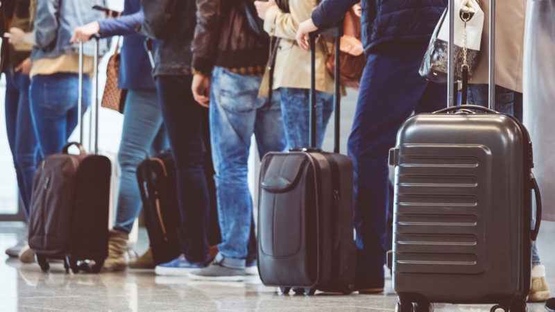Group Of People Standing In Queue At Boarding Gate