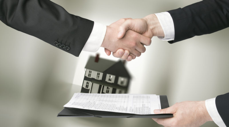 People Shaking Hands In A Real Estate Transaction