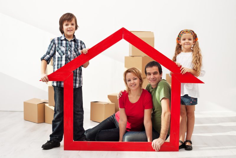 Happy Family With Two Kids Moving Into Their New Home Sitting