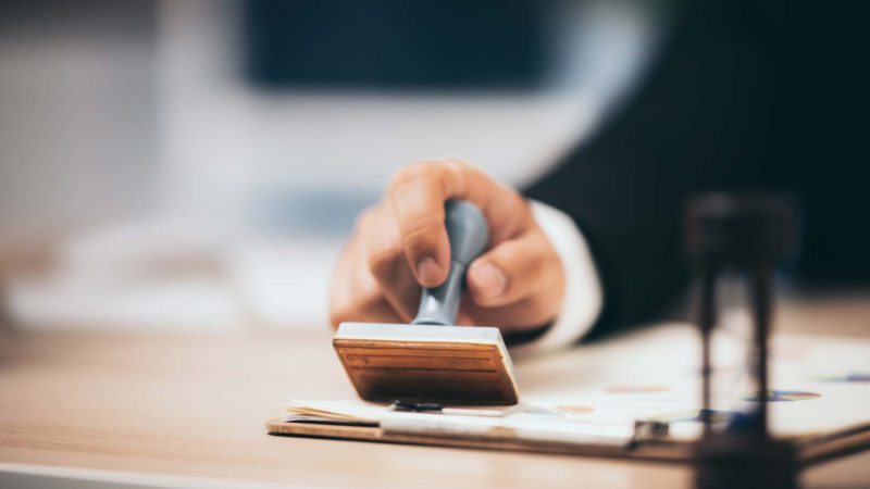 Young Business Man Appoval Stamper Stamp On Paper